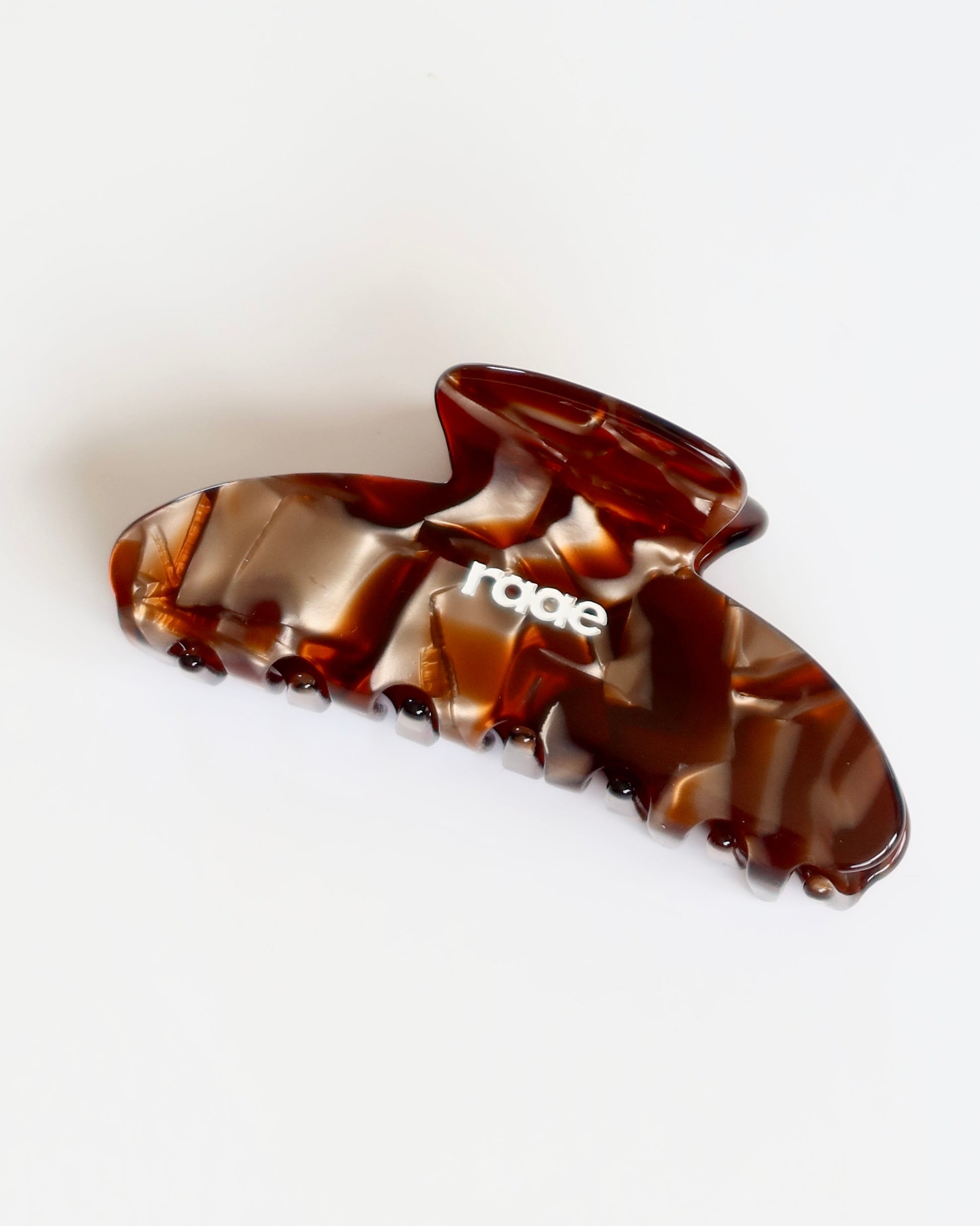 Tortoiseshell hair clip with 'raae' branding on a white background